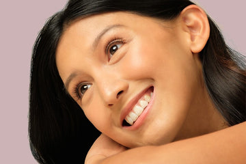 Woman smiling, enjoying her glowing, clear skin